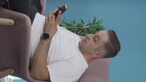 Vertical-video-of-Disappointed-man-texting.
